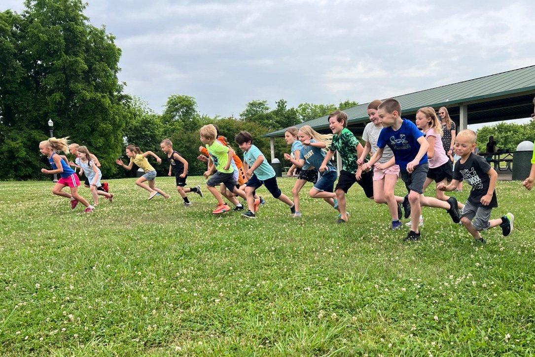 Students racing across the grass at AliYah Academy Field Day