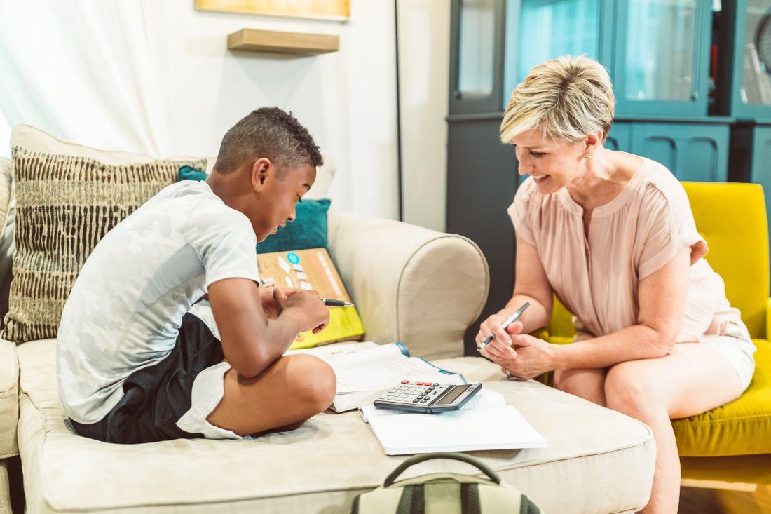 A mother helping her son work through a math lesson at home